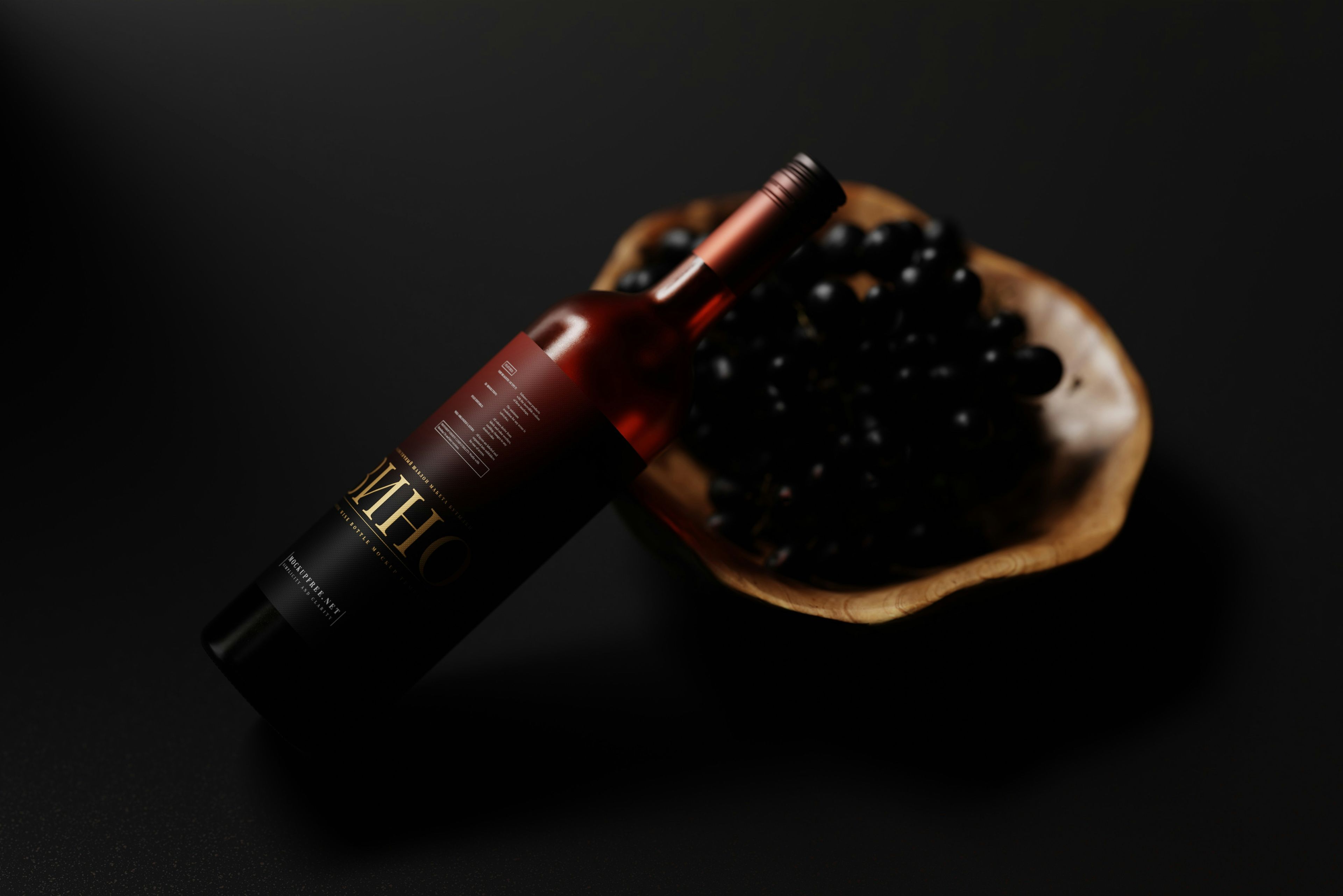 Bottle of wine leaning against a bowl of grapes
